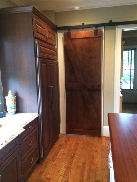 A sliding door is perfect for dividing rooms and hiding messes! The Decorative Barn Door - By the Superhandyman!