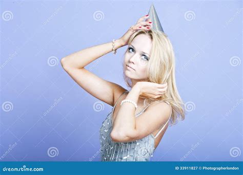 Blonde Party Girl Wearing Silver Dress And Party Hat Stock Image