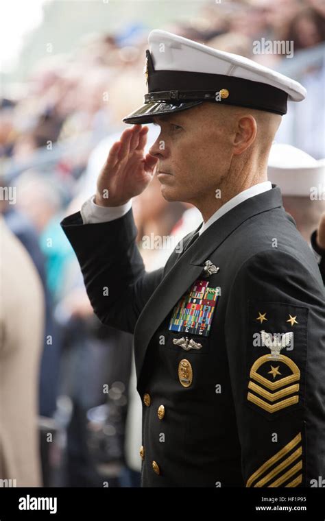 A Us Navy Master Chief Petty Officer Salutes During The National
