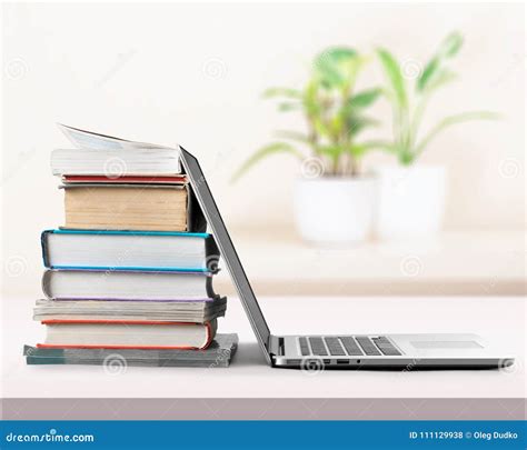 Stack Of Books With Laptop On Light Background Stock Photo Image Of