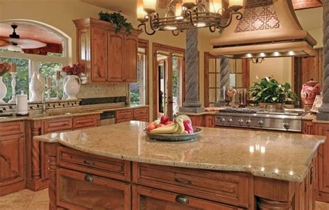 The open layout of the kitchen helps it make the space look brighter and more spacious, while the high, gabled ceiling is a perfect match to the kitchen cabinets, using planks of cherry wood, which also adds. Santa Cecilia granite countertops for a fresh and modern ...