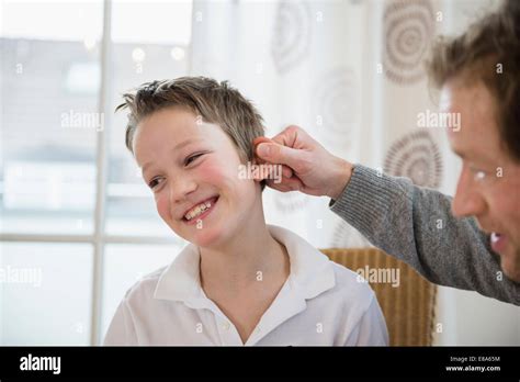 Father Pulling Sons Ear Stock Photo Alamy