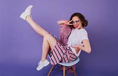 shoes chair debonair cheerful sunglasses posing smile sitting stunning brunette purple woman young wall girl