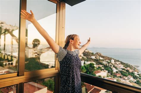 Young Girl Admiring Beautiful Landscape From The Balcony Stock Photo