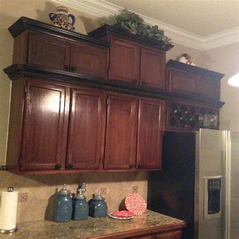 A Kitchen With Wooden Cabinets And Granite Counter Tops On Top Of A
