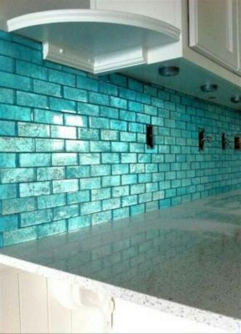 The kitchen peninsula with butcher block countertop is used as a small library besides its main function. Aqua tile | Home, Design, Home decor