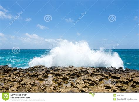 Waves Crashing Over Limestone Ocean Coastline Royalty Free
