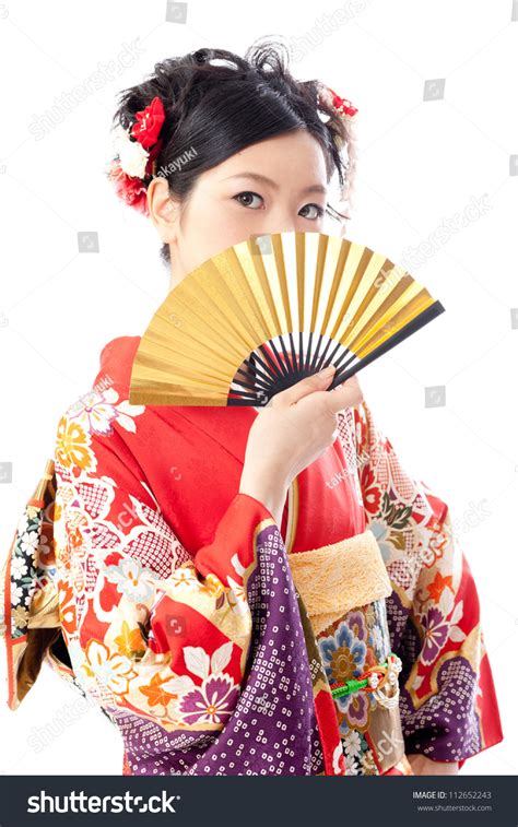 attractive asian woman wearing japanese kimono holding traditional fan on white background stock