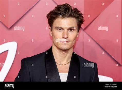 Oliver Cheshire Poses For Photographers Upon Arrival At The British Fashion Awards In London