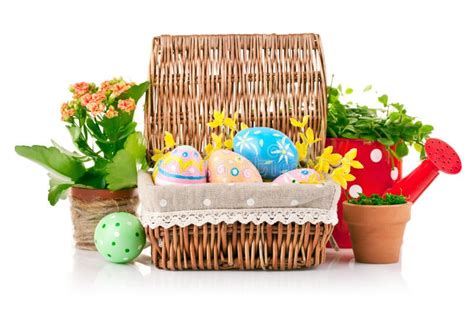 Easter Eggs In Basket With Spring Flowers And Green Leaves Stock Photo