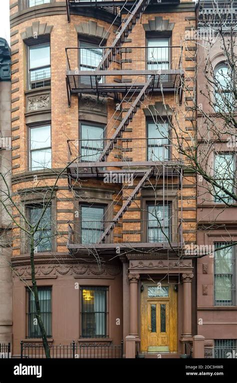 Typical New York City Apartment Building With Fire Escape Ladders And