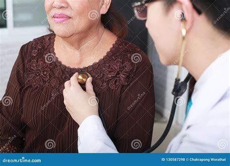 Doctor Using Stethoscope To Exam Woman Patient Heart Stock Photo