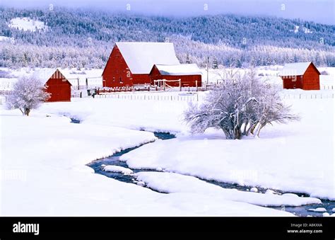 Usa Idaho A Landscape Of Snow Covered Mountains And Winter Farm With