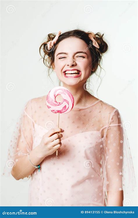 beautiful brunette girl with candy in her hands stock image image of modern lollipop 89413155