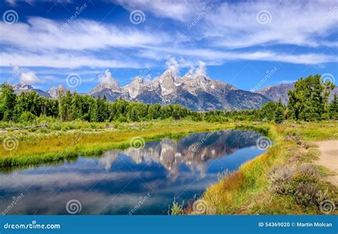 Landscape View Of Grand Teton Mountains With Water Reflection Stock