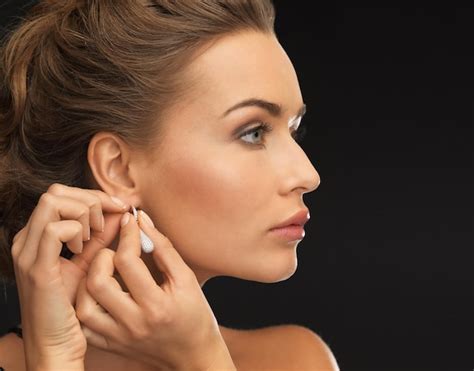 Premium Photo Close Up Of Beautiful Woman Wearing Shiny Diamond Earrings