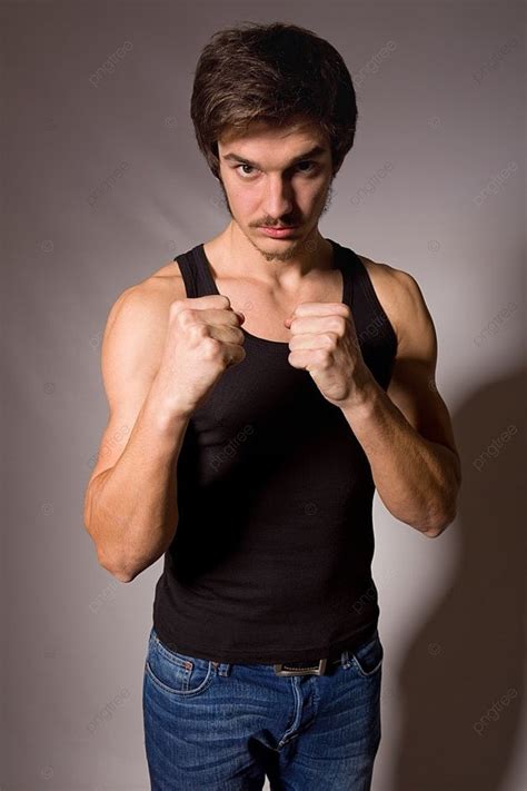 Studio Portrait Of A Handsome Young Man Showing His Fists Photo