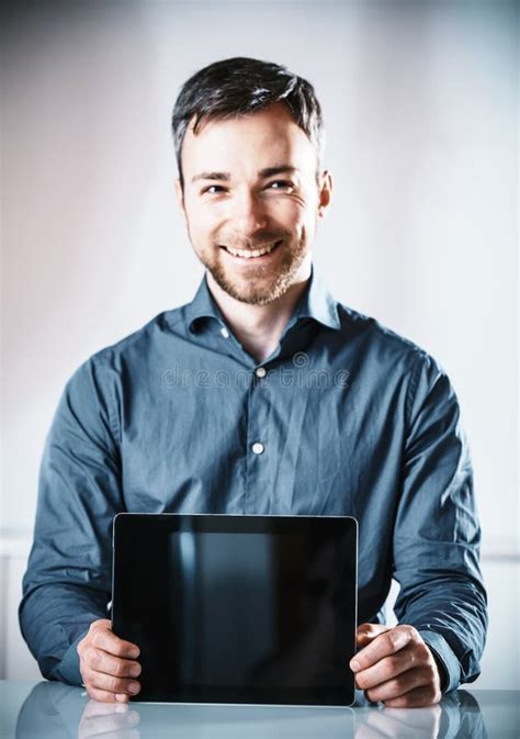 Young Man Holding Up A Blank Tablet Pc Stock Photo Image Of