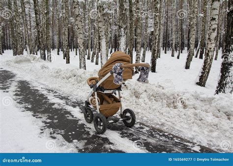 Snowy Baby Stroller In Winter Forest Tire Tracks On Snow Stock Image