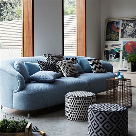 Modern Living Room With Blue Sofa And Poufs Decorating