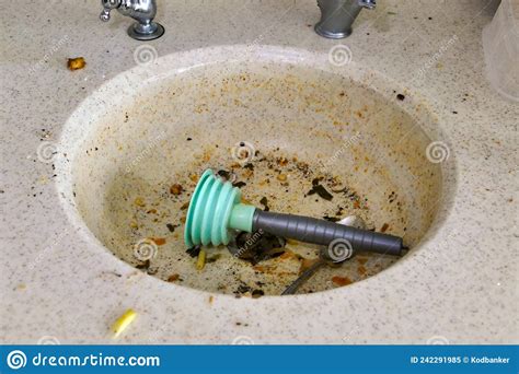 Using A Plastic Kitchen Pump To Unclog The Kitchen Sink Stock Image