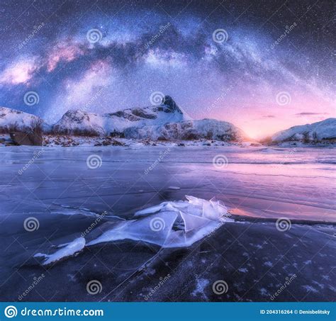 Milky Way Above Frozen Sea Coast And Snow Covered Mountains Stock Photo