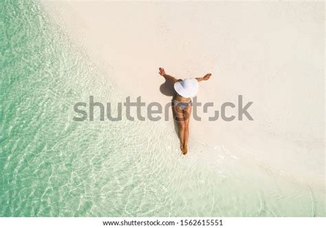 Summer Holiday Fashion Concept Tanning Girl Wearing Sun Hat At The Beach On A White Sand Shot