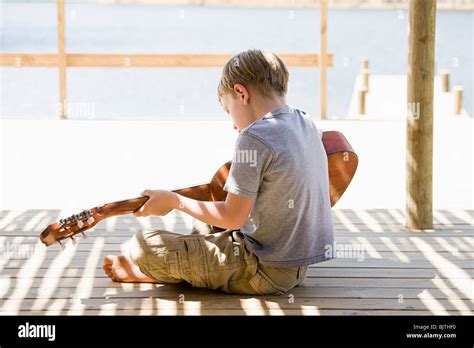 Boy Playing Guitar Stock Photo Alamy