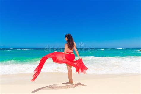 Young Beautiful Asian Girl With Red Cloth On The Beach Of A Tropical
