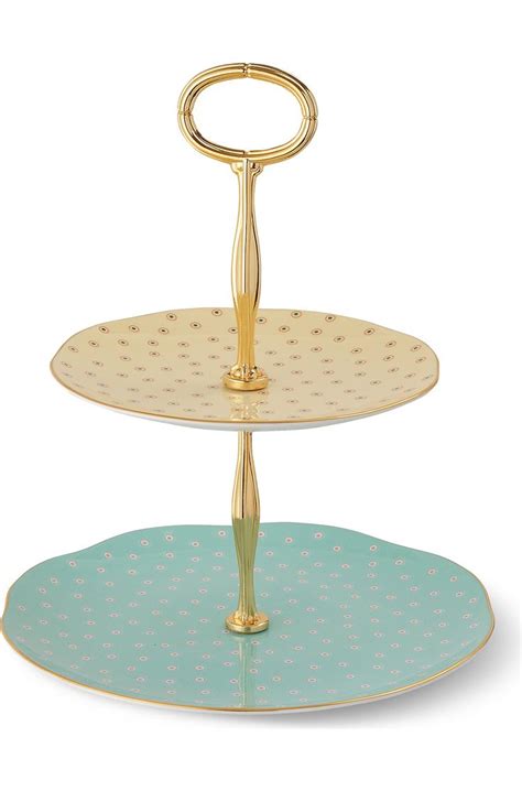 Two Tiered Cake Stand With Blue And Gold Designs On The Bottom One