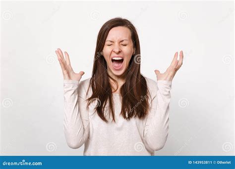 Portrait Of Crazy Screaming Young Woman In Light Clothes Keeping Eyes