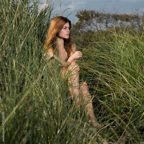 Beautiful Woman With Pure Natural Beauty Skin Sit On Green Grass In The