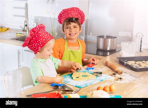 Children Cut Out Forms From Dough For Cookies Stock Photo Alamy