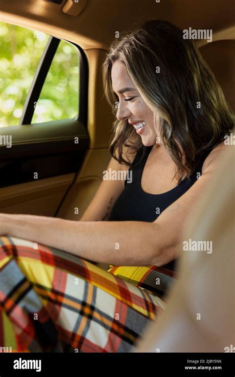 Portrait Of Caucasian Woman Laughing In Backseat Of Luxury Sedan Stock