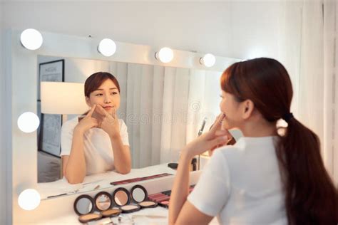 Young Asian Woman Touching Skin Face In Front Of Mirror Stock Image Image Of Facial Mirror