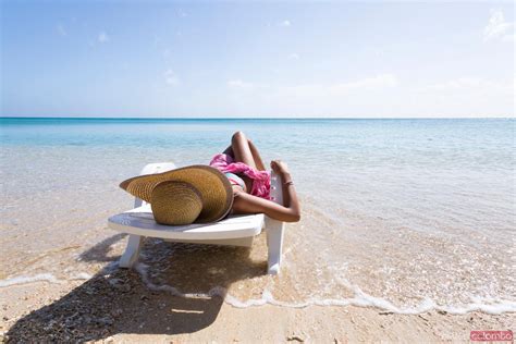 Woman Laying Down On Sunchair On A Beach In Summer Royalty Free Image
