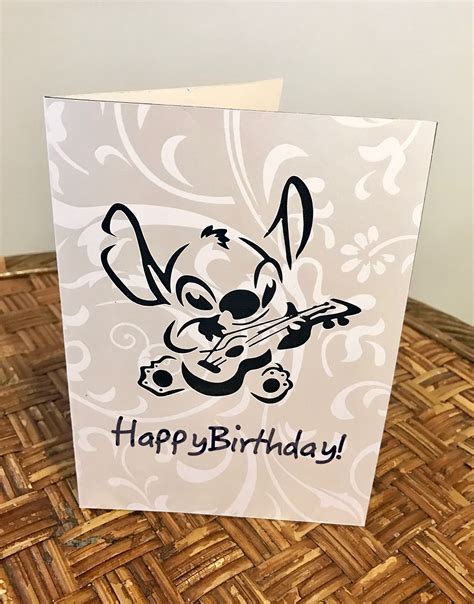 A Birthday Card With An Image Of A Cartoon Character Playing The Guitar On Top Of It