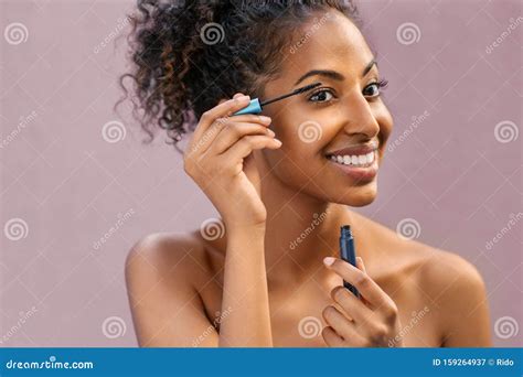 African Young Woman Applying Mascara Stock Image Image Of Elegance