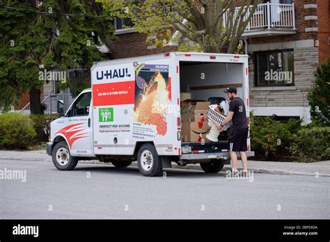 U-Haul moving truck loaded bu young male with boxes and furniture by