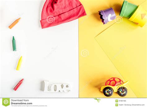 kids desk design  toys  clothes yellow white background top view mockup stock image