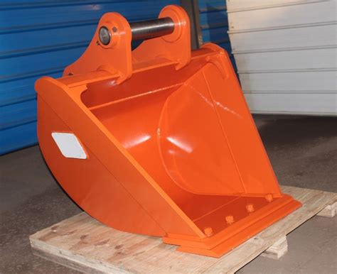 An Orange Snow Plow Sitting On Top Of A Wooden Pallet