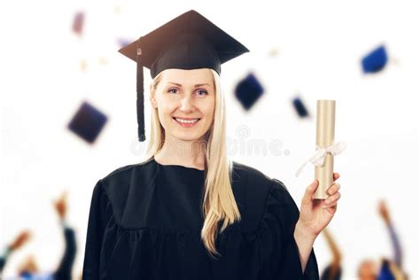 College Graduation Woman Wearing Gown Showing Diploma Stock Image
