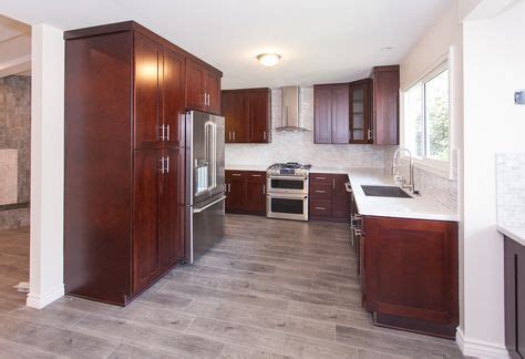 People are looking for fresh, light and casual. gray wood floors, warm cherry cabinets, white counters ...
