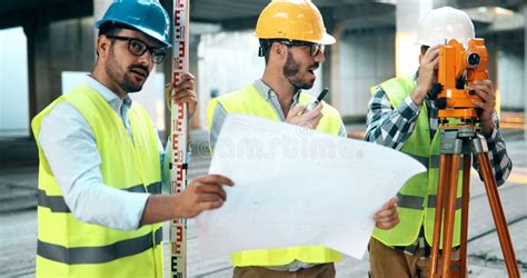 Team Of Construction Engineers Working On Building Site Stock Image
