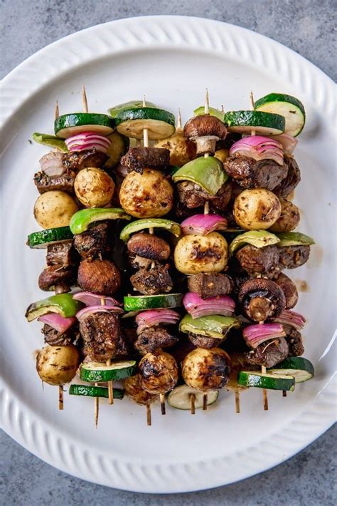An Image Of Steak Skewered On Wooden Skewers With Zucchini Onions