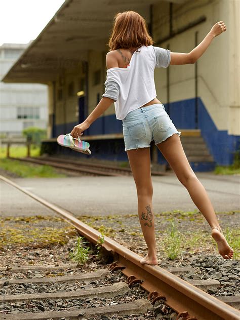 Girl Balancing On Tracks By Stocksy Contributor Simon Bolz Stocksy