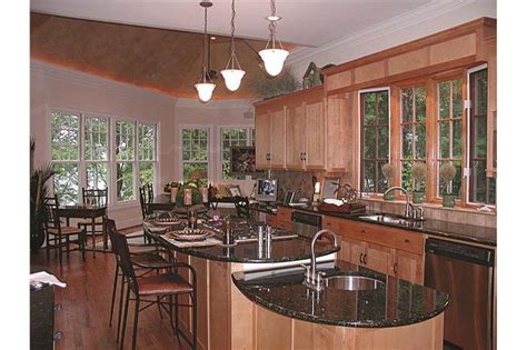 A Large Kitchen With Wooden Cabinets And Black Counter Tops Along With