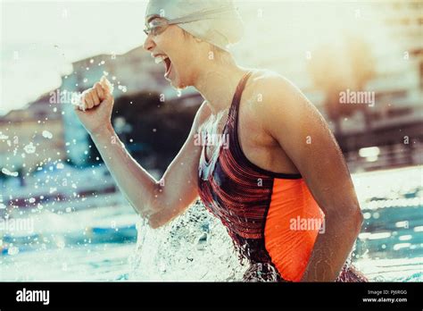 Excited Female Swimmer With Clenched Fist Celebrating Victory In The Swimming Pool Woman