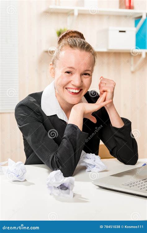 Creative Worker Smiling In Office And Crumpled Paper Stock Photo