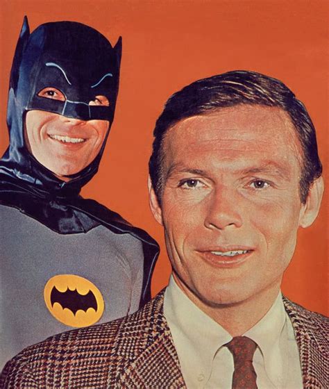 A Man In A Suit And Batman Mask Next To Another Man Wearing A Suit With